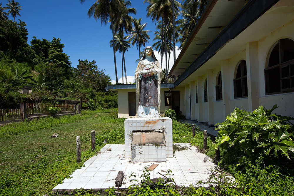In front of an abandoned church in Poso.