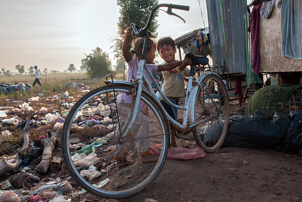 Two children in front of one of the houses on a garbage dump in Siem Reap.