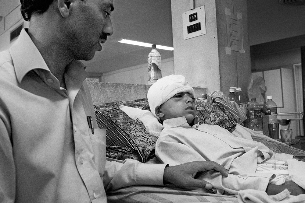 Srinagar hospital. A six year old boy wounded during a street fight and his father.